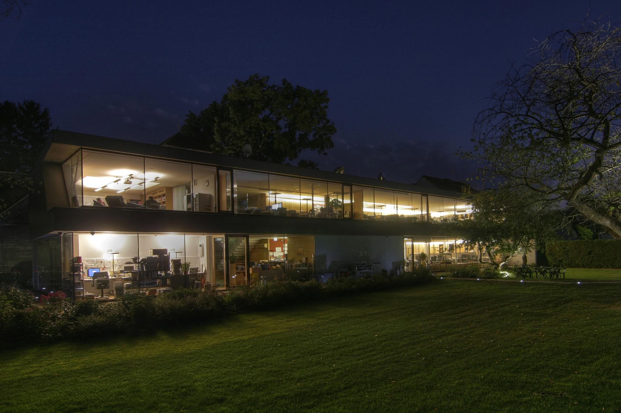 The Magora office in the Waldviertel at night, lit from inside
